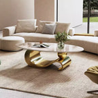 Table basse ovale de 124 cm avec plateau en pierre frittée imitation marbre et piètement sculptural en acier inoxydable