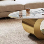 Table basse ovale de 124 cm avec plateau en pierre frittée imitation marbre et piètement sculptural en acier inoxydable