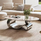 Table basse ovale de 124 cm avec plateau en pierre frittée imitation marbre et piètement sculptural en acier inoxydable